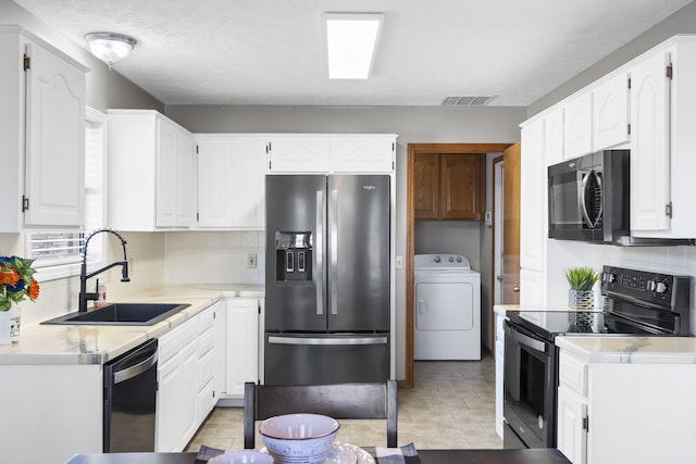 kitchen with washer / dryer, sink, white cabinetry, electric range oven, and stainless steel fridge