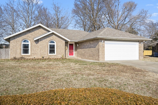 ranch-style house featuring a garage and a front yard