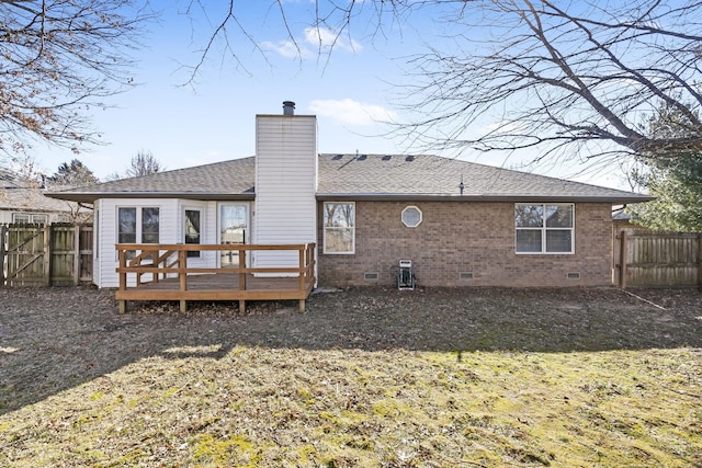 rear view of house with a deck and a lawn