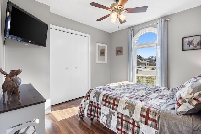 bedroom with wood-type flooring, a closet, and ceiling fan