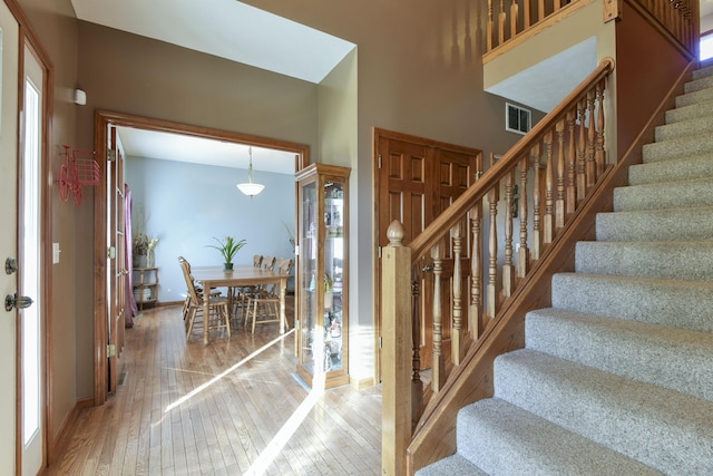 stairs featuring hardwood / wood-style flooring