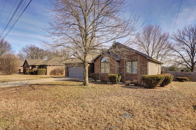 ranch-style house with a garage and a front lawn