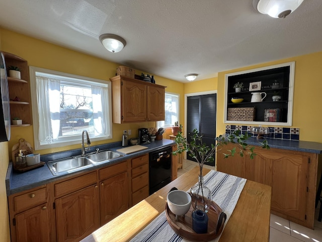 kitchen with dark countertops, a sink, black dishwasher, a textured ceiling, and open shelves