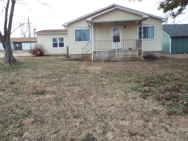 view of front of house with a front yard and a porch