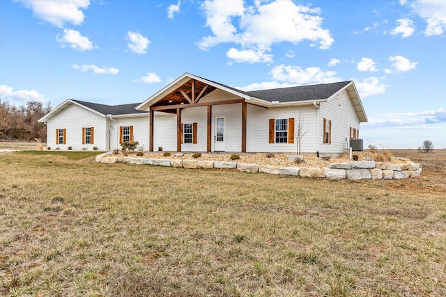 view of front of property with a front lawn and central air condition unit