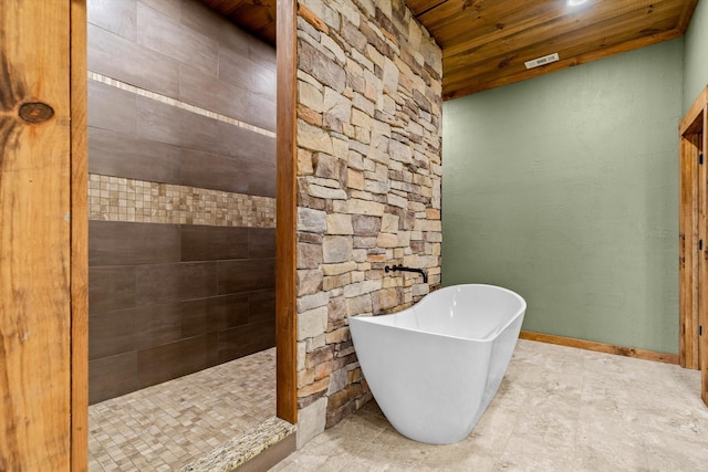 bathroom featuring a tub to relax in and wooden ceiling