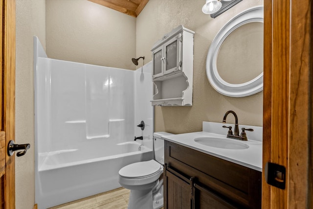 full bathroom featuring vanity, bathing tub / shower combination, and toilet