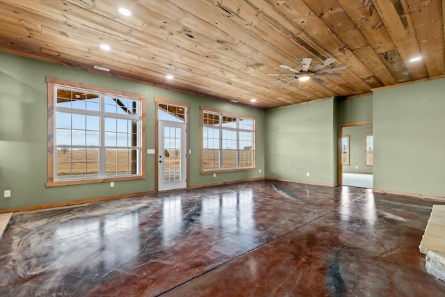 unfurnished room featuring wood ceiling, ceiling fan, and concrete flooring