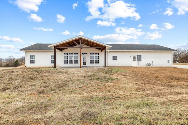 rear view of house with a yard