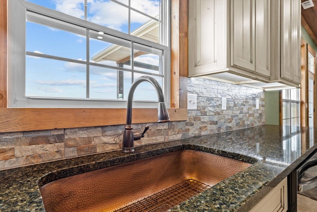 room details featuring sink and dark stone counters