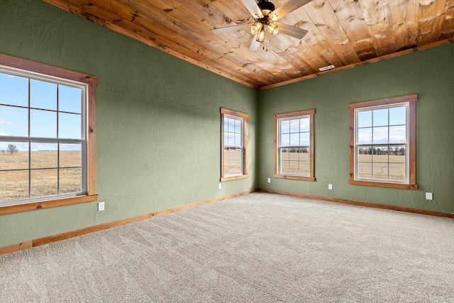 carpeted empty room with wood ceiling and ceiling fan