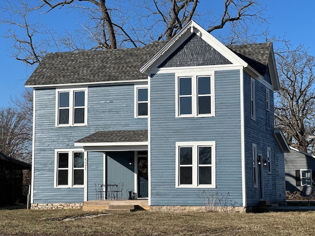 rear view of property featuring a yard