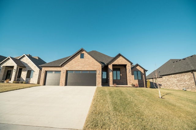 view of front of property featuring a garage and a front yard