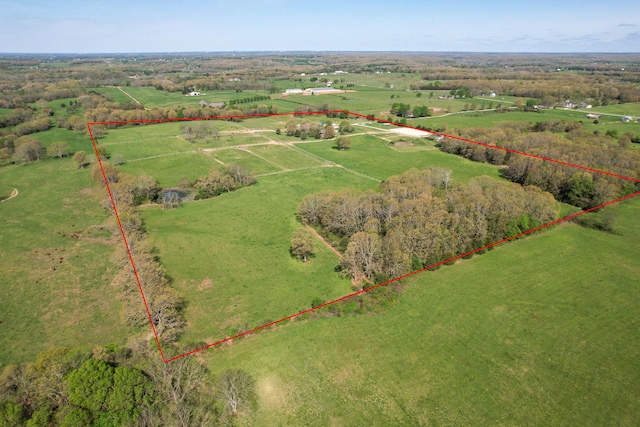 birds eye view of property with a rural view