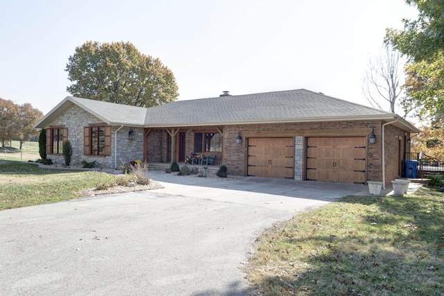 ranch-style house with a garage, a front yard, and covered porch