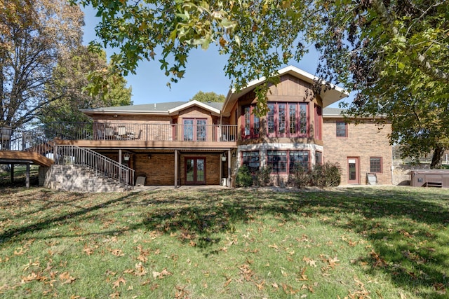 rear view of house featuring a yard and a deck