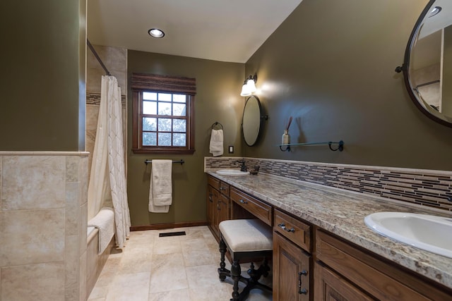 bathroom with vanity, shower / tub combo, tile patterned flooring, and tasteful backsplash