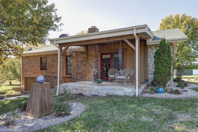 back of house featuring a lawn and a patio