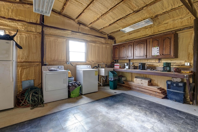 laundry area featuring washing machine and clothes dryer and sink