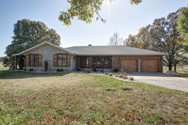 ranch-style home featuring a garage and a front yard