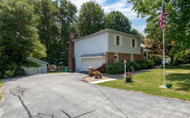 view of side of property featuring a yard and a garage