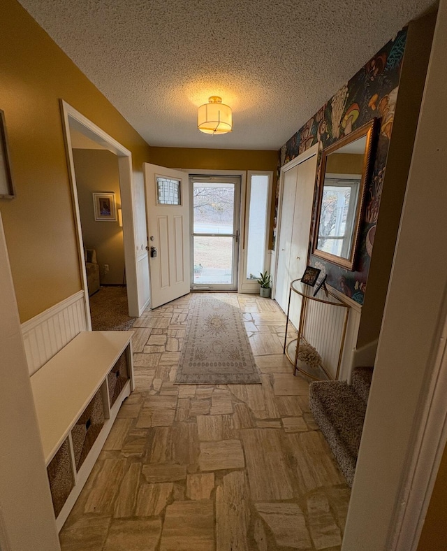 doorway with a textured ceiling