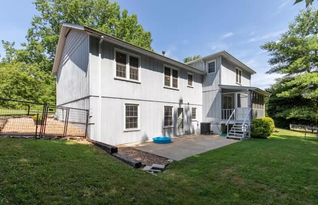 rear view of house with a yard, central AC, a sunroom, and a patio area