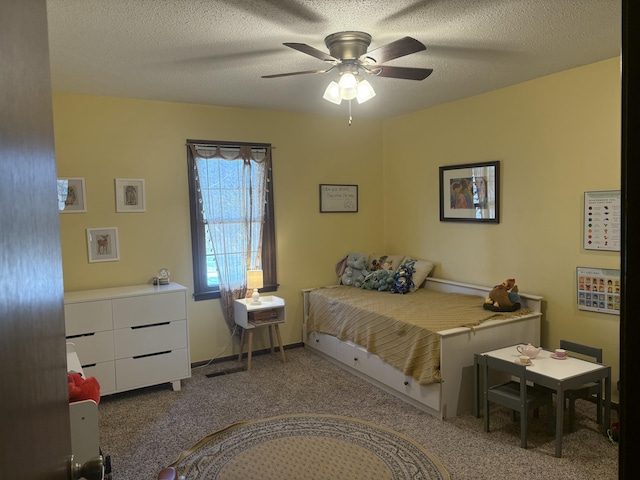 carpeted bedroom with a textured ceiling and ceiling fan