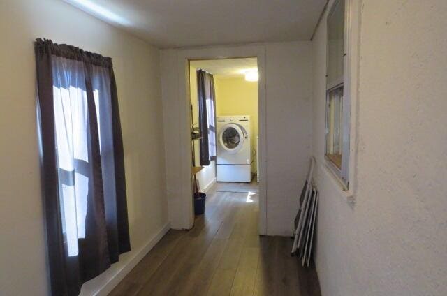 corridor with washer / clothes dryer and dark hardwood / wood-style flooring