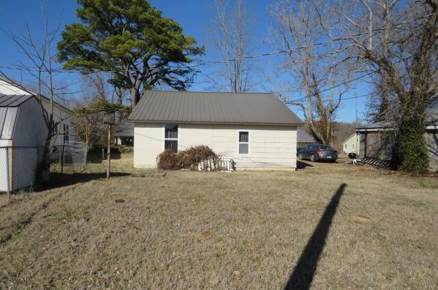 view of outbuilding featuring a lawn