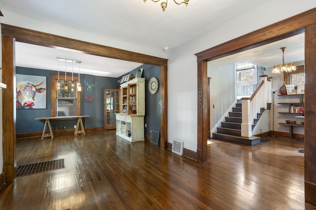 interior space featuring an inviting chandelier and dark hardwood / wood-style floors