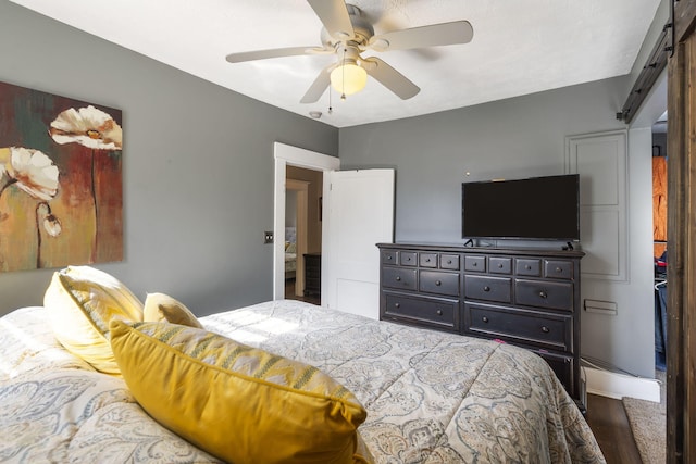 bedroom with ceiling fan and hardwood / wood-style floors