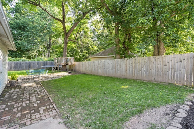 view of yard featuring a trampoline and a patio area