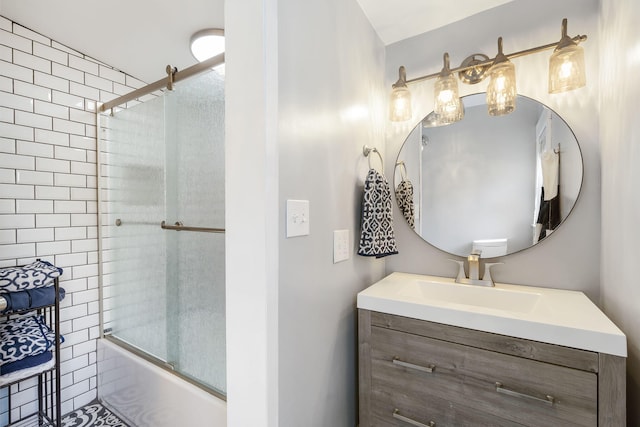 bathroom featuring vanity and combined bath / shower with glass door