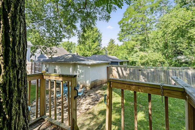 wooden deck featuring a yard