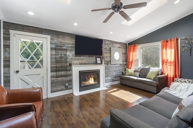 living room featuring ceiling fan, dark hardwood / wood-style floors, and vaulted ceiling