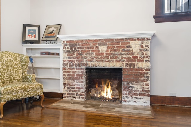 room details featuring a brick fireplace and hardwood / wood-style floors