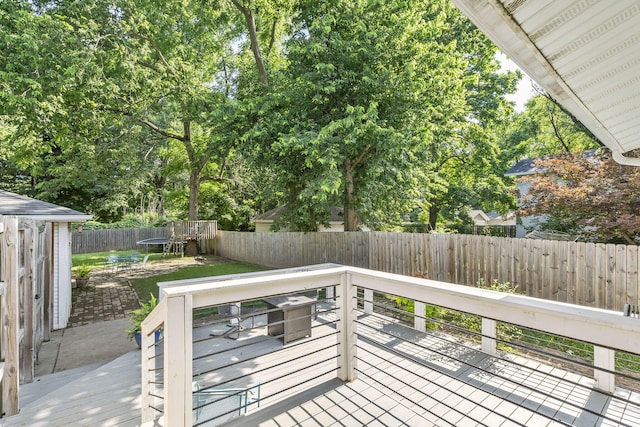 wooden deck with a patio area and a fire pit