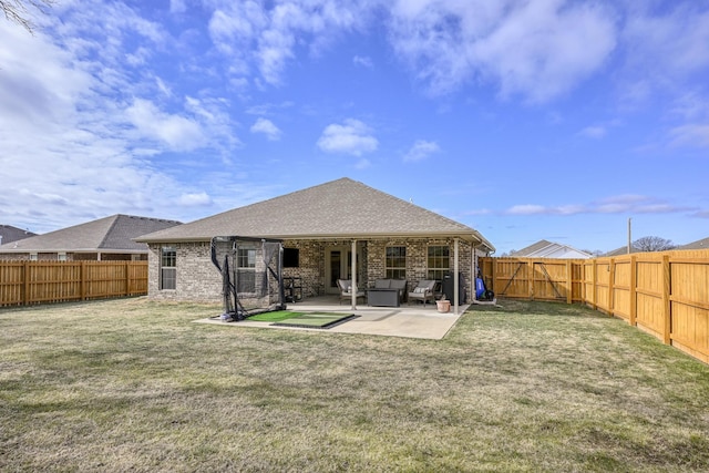 back of property featuring a patio and a yard