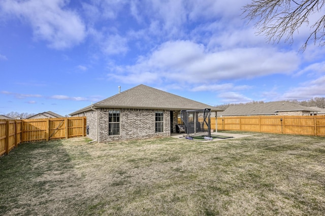 rear view of property with a lawn and a patio