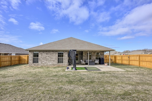 rear view of property featuring a yard and a patio