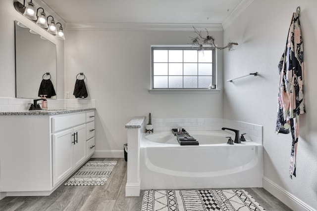 bathroom featuring vanity, a washtub, crown molding, and hardwood / wood-style floors