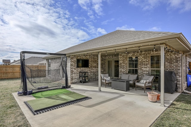 back of property with an outdoor living space and a patio