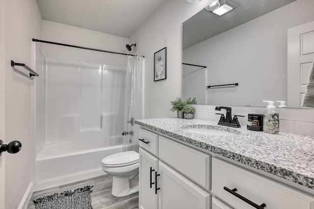 full bathroom with shower / bathtub combination with curtain, vanity, and toilet