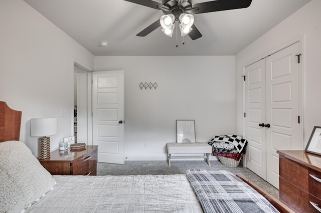 carpeted bedroom with ceiling fan and a closet