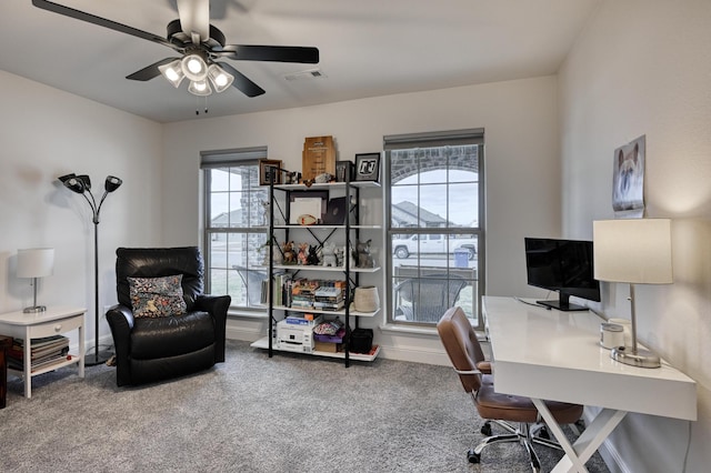 carpeted office space featuring ceiling fan