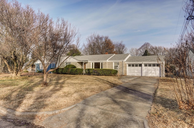 ranch-style house featuring a garage and a front lawn