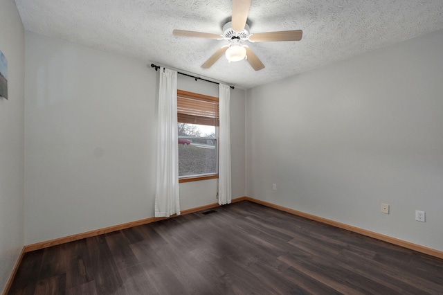 spare room featuring ceiling fan, dark hardwood / wood-style floors, and a textured ceiling