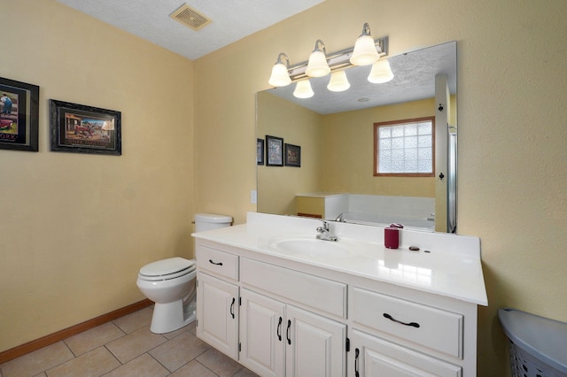 bathroom with tile patterned flooring, vanity, a textured ceiling, and toilet