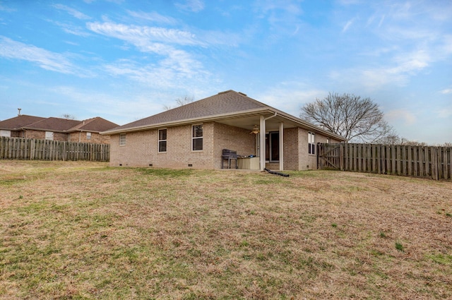 back of house featuring a yard